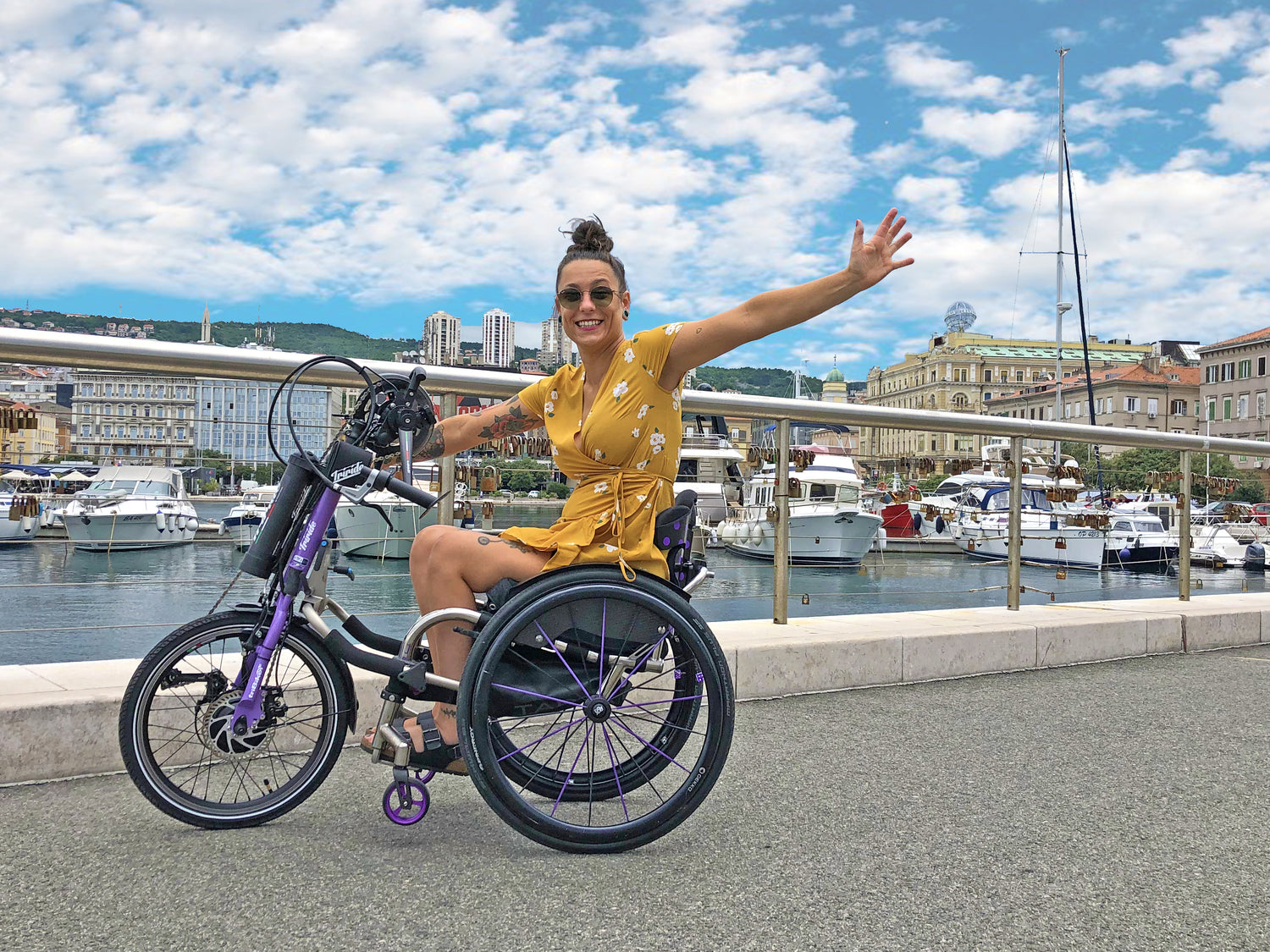 Lady in a wheelchair using a Triride handbike. 