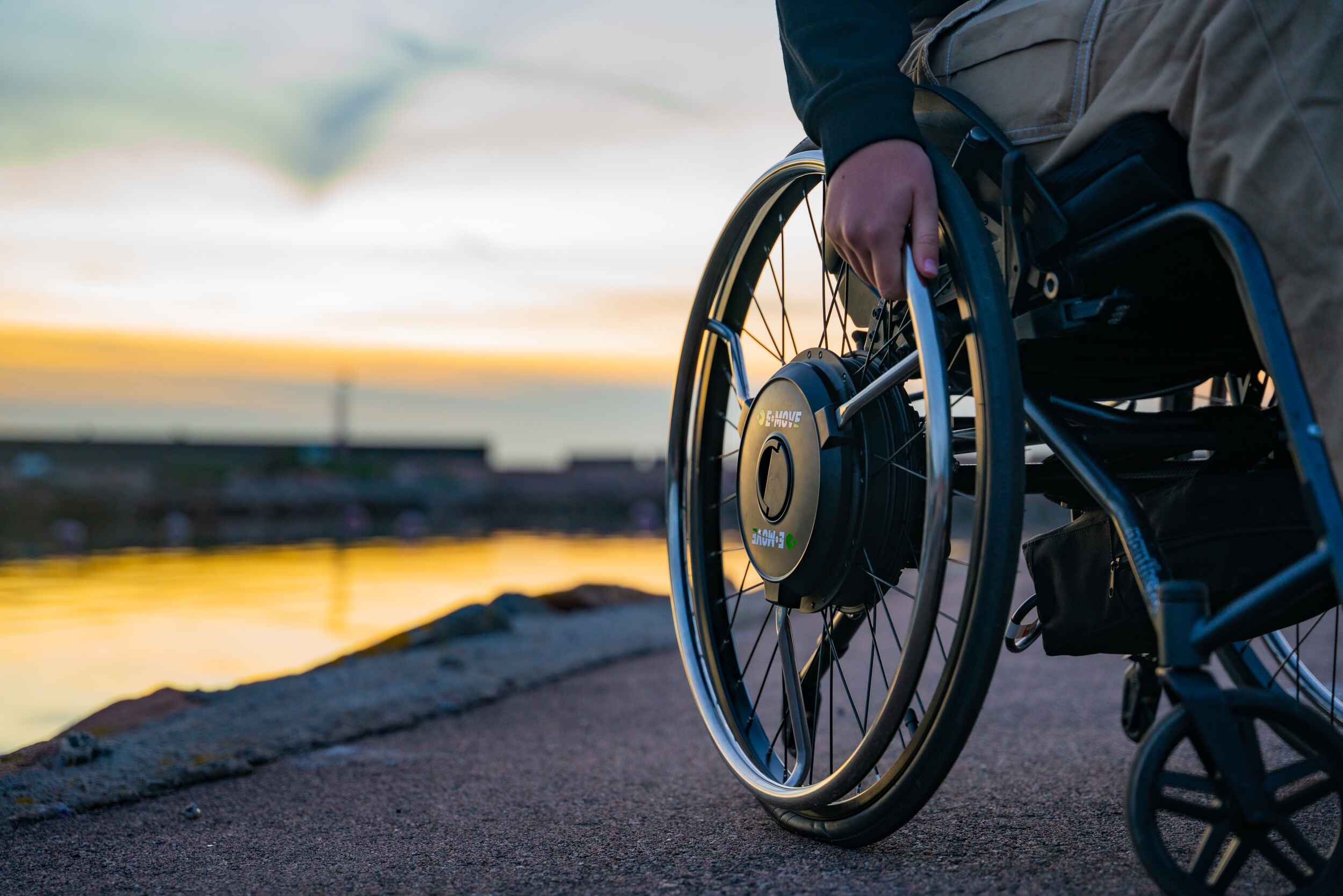 Decon E-Move Blackline - Hub-Mounted power assist device for manual wheelchairs. Available from Beyond Mobility.