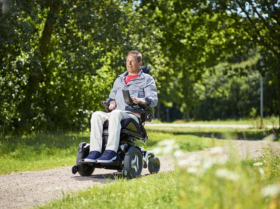 Man driving Permobil F5 Corpus on rough ground