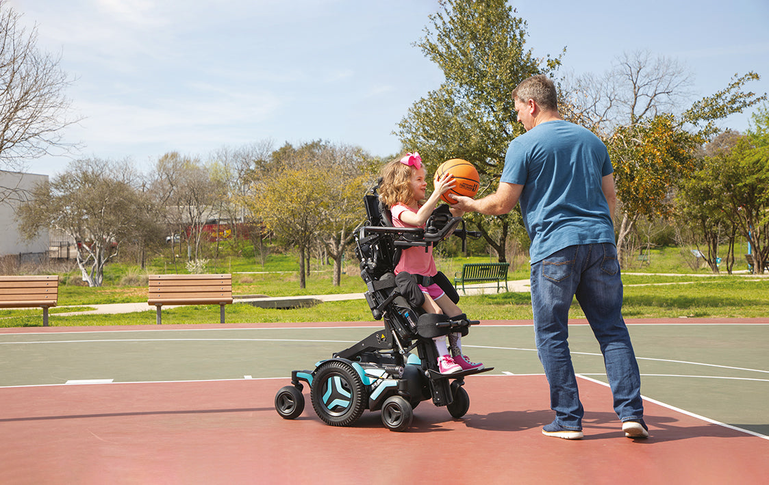 Permobil M Corpus VS from Beyond Mobility - Young girl playing basketball with her father